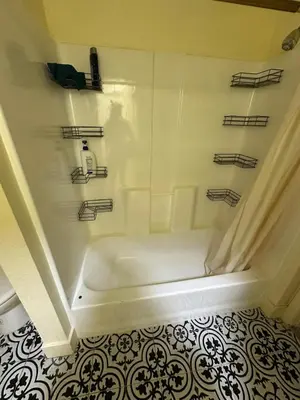 a white bath tub in a bathroom with a tile floor at Shared but isolated room in Central Los Angeles in Los Angeles