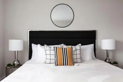 a bedroom with a large bed with a mirror on the wall at Relax in Spacious 4BR Home Sleeps 8 with Parking in North Hollywood