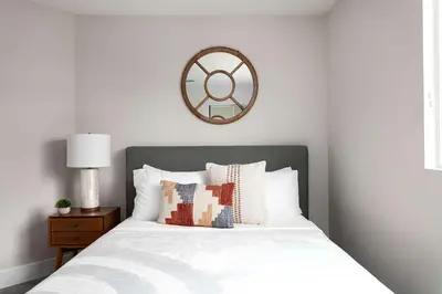 a bedroom with a bed with a mirror on the wall at Relax in Spacious 4BR Home Sleeps 8 with Parking in North Hollywood