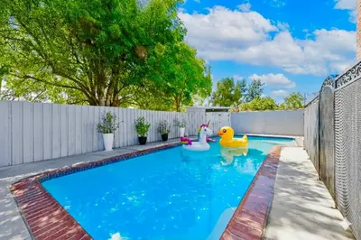a swimming pool with a rubber duck in a backyard at Heated Pool Oasis Close to Attractions in Encino