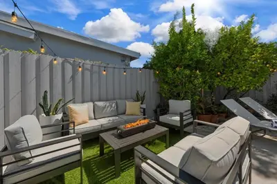 a patio with a couch and chairs and a fire pit at Heated Pool Oasis Close to Attractions in Encino