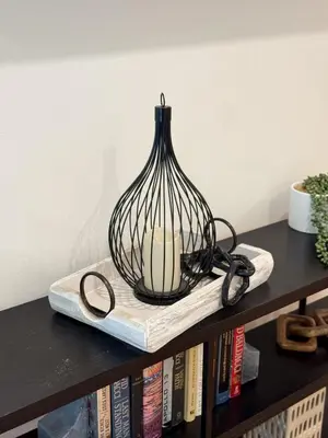 a black vase sitting on top of a book shelf at Modern Tarzana Poolside Retreat in Tarzana