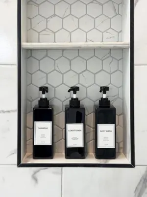 three bottles of soap sitting on a shelf at Modern Tarzana Poolside Retreat in Tarzana