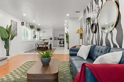 a living room with a blue couch and a table at Stylish Getaway with Hot Tub in Northridge Hospital Heliport