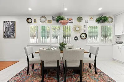 a dining room with a table and chairs at Stylish Getaway with Hot Tub in Northridge Hospital Heliport