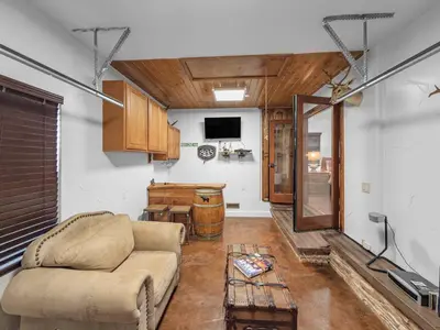 a living room with a couch and a table at Mountain Deer Cabin W Foosball & Fenced Backyard in Big Bear City