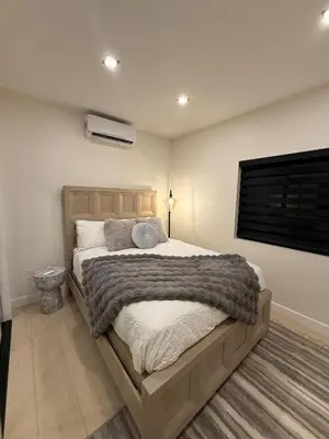 a bedroom with a large bed and a window at SkyLoft in Woodland Hills