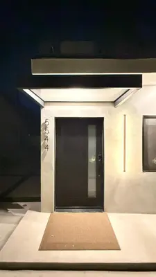 a black door on a building with a mat in front at SkyLoft in Woodland Hills