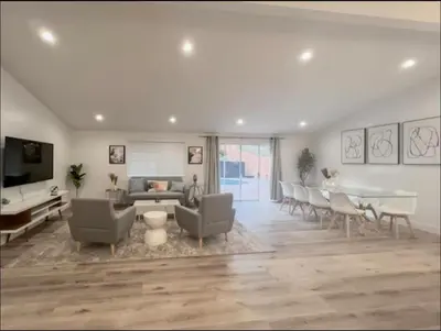 a living room with a couch and a table at stunning Poolside villa