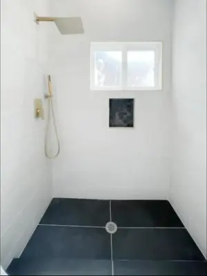 a white bathroom with a shower and a window at stunning Poolside villa