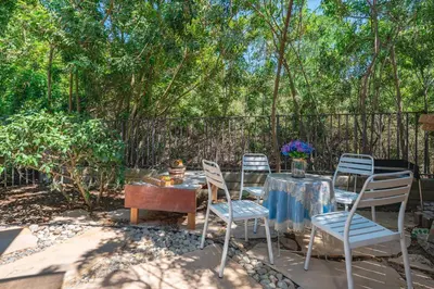 a patio with a table and chairs and a fence at Modern Cozy Stay w Outdoor Patio & Grill in Pomona