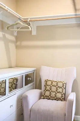 a room with a white chair and a shelf at Modern Cozy Stay w Outdoor Patio & Grill in Pomona
