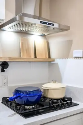 a stove top with a pot and a pan on it at Modern Cozy Stay w Outdoor Patio & Grill in Pomona