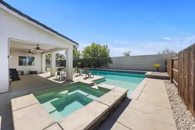 a swimming pool in the backyard of a house at Spacious Home with Private Pool in Bakersfield