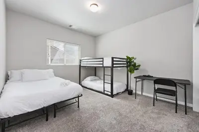 a bedroom with a bunk bed and a desk at Spacious Home with Private Pool in Bakersfield