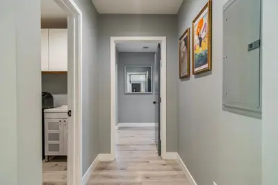 a hallway with white walls and wooden floors at Luxury Summer Getaway in Encino in Van Nuys Airport