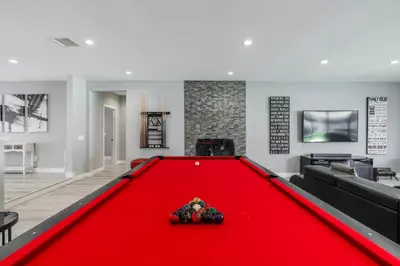 a pool table in a living room with a red blanket at Luxury Summer Getaway in Encino in Van Nuys Airport