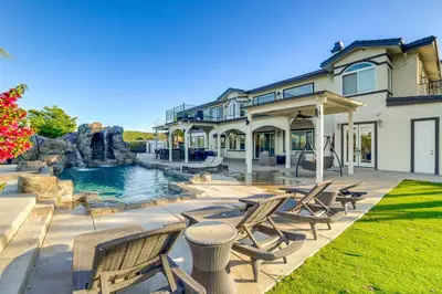 a large house with a swimming pool and chairs at Expansive Riverside Mansion! Luxe, Family Friendly in Riverside