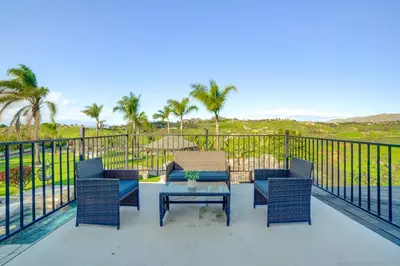 a patio with a table and chairs on a balcony at Expansive Riverside Mansion! Luxe, Family Friendly in Riverside