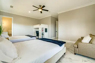 a bedroom with two beds and a ceiling fan at Expansive Riverside Mansion! Luxe, Family Friendly in Riverside