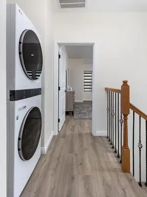 a hallway with a washer and dryer in a house at Luxurious Pasadena Home w Parking & Near Old Town in Pasadena