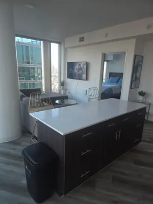 a kitchen with a large island in a living room at 2 Bedroom with City Views in Los Angeles