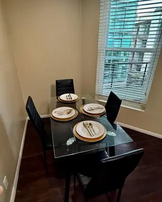 a dining room table with four chairs and a window at The Luxe Marina HideAway in Los Angeles