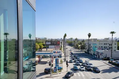 a city street with cars parked in a parking lot at LA Hype Spot Sunset x Fairfax SkyView in Los Angeles