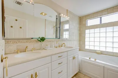 a bathroom with a tub and a sink and a mirror at 5 bedroom home 2 miles from Loma Linda Medical in Loma Linda