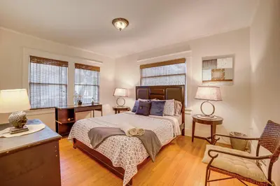 a bedroom with a bed and a desk and a chair at Home half Mi to Dtwn Riverside Families Welcome! in Riverside