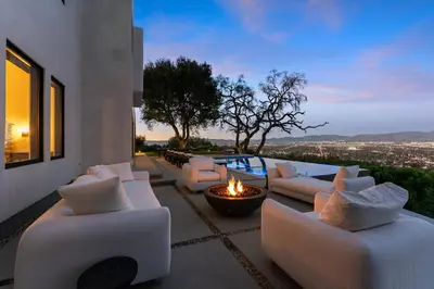 a patio with white couches and a fire pit at Mulholland Edition in Beverly Hills