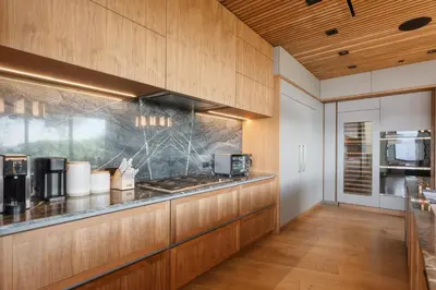 a kitchen with wooden cabinets and a counter top at Mulholland Edition in Beverly Hills