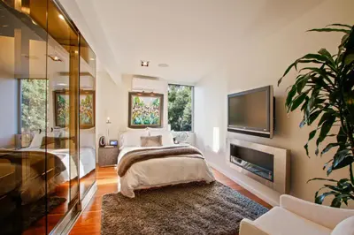 a bedroom with a bed and a flat screen tv at The Beverly Aura in Los Angeles