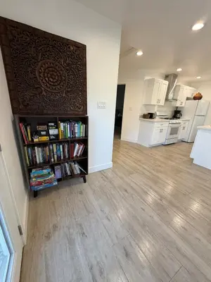 a living room with a book shelf filled with books at Brand New Home, Great Location, Monthly Discounts in Woodland Hills