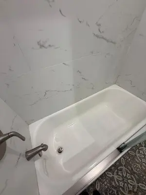 a white sink in a bathroom with a marble wall at Brand New Home, Great Location, Monthly Discounts in Woodland Hills