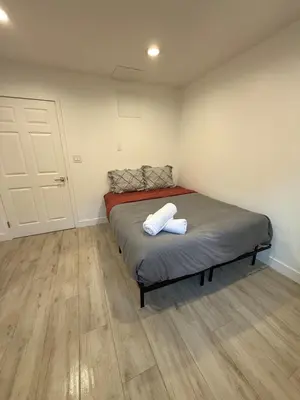 a bedroom with a bed with two towels on it at Brand New Home, Great Location, Monthly Discounts in Woodland Hills