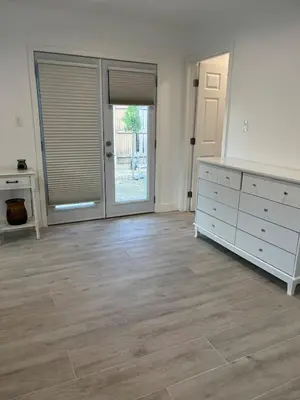 an empty living room with a dresser and a door at Brand New Home, Great Location, Monthly Discounts in Woodland Hills