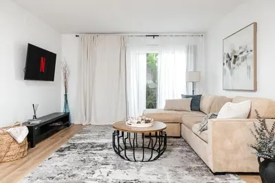 a living room with a couch and a table at Serene Urban Haven in Los Angeles