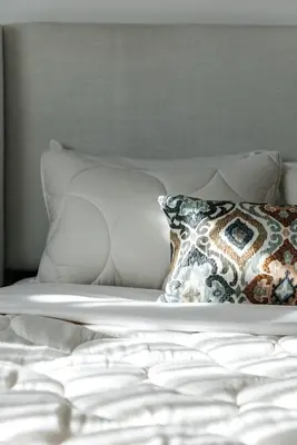 a white bed with a pillow on it at Serene Urban Haven in Los Angeles