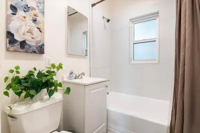 a bathroom with a toilet and a sink and a mirror at Affordable 1BR apt near Beverly Hills in Los Angeles
