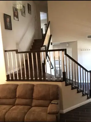 a living room with a couch and a staircase at Peaceful Room in Riverside