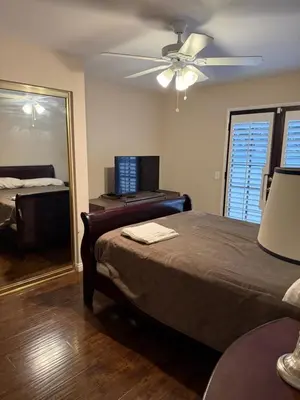 a bedroom with a bed and a ceiling fan at Peaceful Room in Riverside