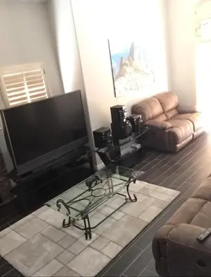 a living room with a flat screen tv and a couch at Peaceful Room in Riverside