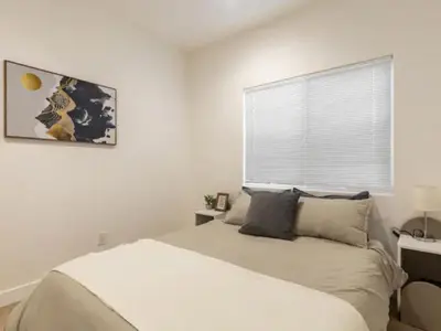 a white bedroom with a bed and a window at Holiday Home Modern Home by Interhome in Westminster