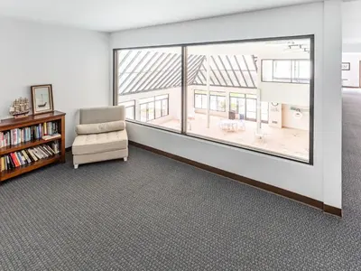 a living room with a chair and a large window at Apartment Meerblick Eigentumswohnung gegenüber dem Strand by Interhome in Port Hueneme