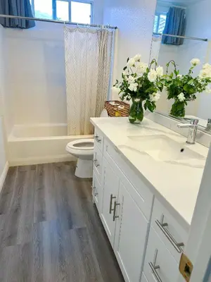 a bathroom with a sink and a toilet and a tub at Big bedroom shared bathroom in Fontana