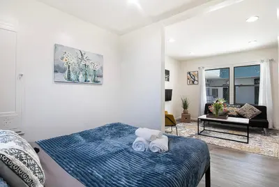 a bedroom with a bed with two towels on it at Cozy Studio Suite Near Beverly Hills in Los Angeles