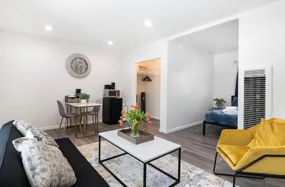 a living room with a couch and a table at Cozy Studio Suite Near Beverly Hills in Los Angeles