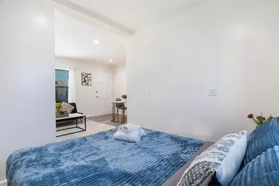 a bedroom with a bed with a blue blanket at Cozy Studio Suite Near Beverly Hills in Los Angeles