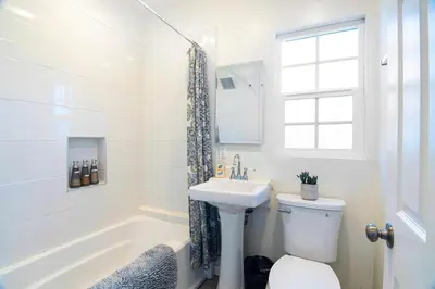a bathroom with a toilet and a sink and a tub at Cozy Studio Suite Near Beverly Hills in Los Angeles